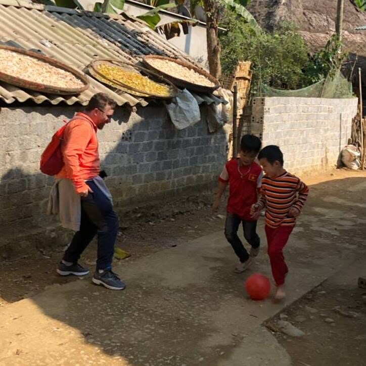 Playing football with local children in a village community
